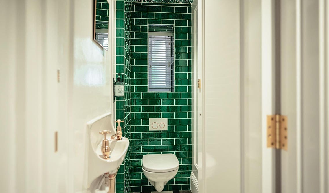 green tiles wall in white bathroom