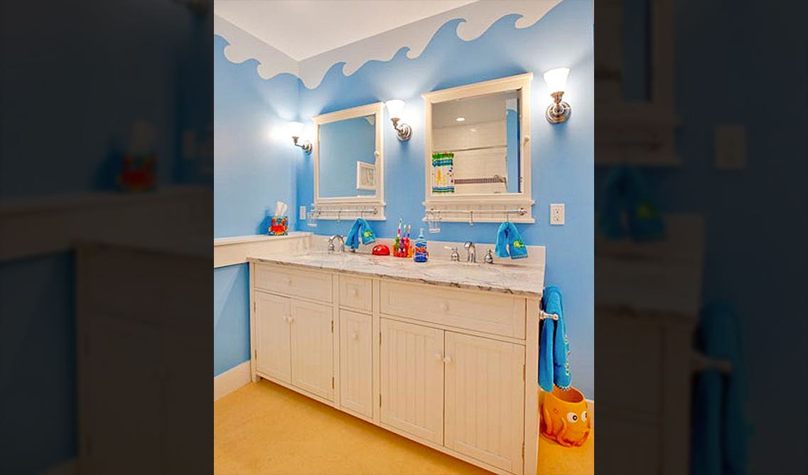 kids' bathroom decorated with white vanity and sea theme