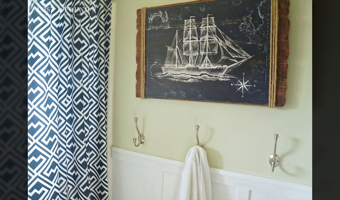 kids' bathroom with blue curtains and hanging hooks