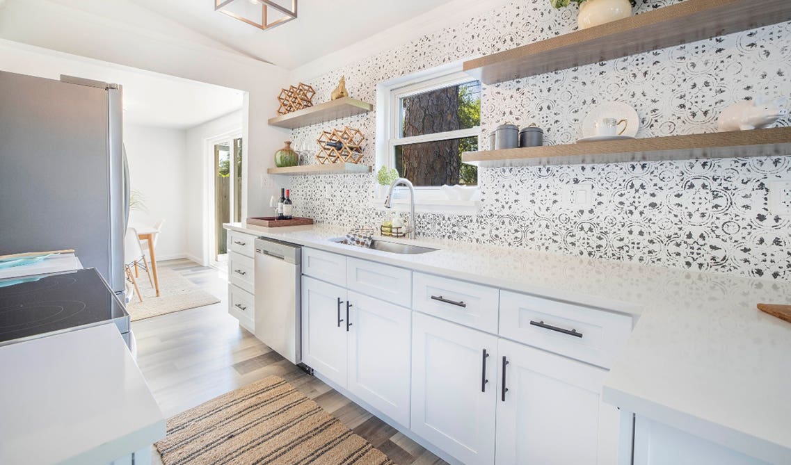 White cabinets with minimal hardware style and floating shelves 